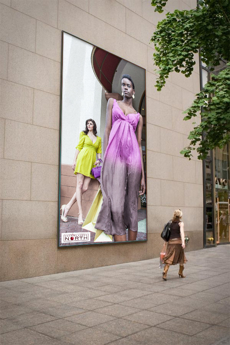 Cherry Creek North advertising campaign, two models in colorful dresses on a building-mounted outdoor ad