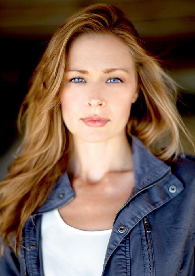 Headshot of model Renae Vespremi in a navy jacket over a white top in Malibu, CA