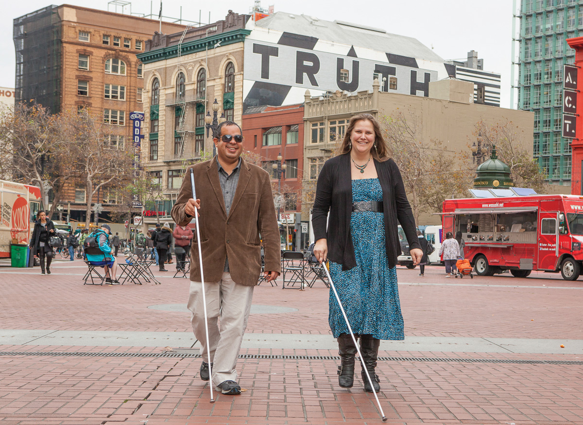 Two people walking with white canes through downtown San Francisco for a LightHouse for the Blind and Visually Impaired campaign
